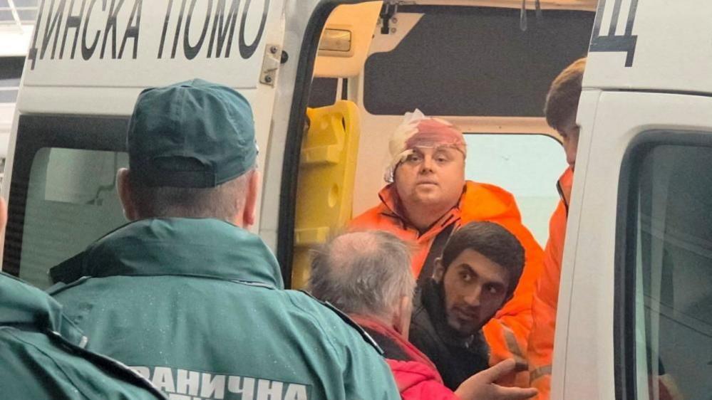 Rescued crew members from a ship that was damaged in a drone attack are taken away in an ambulance in Varna, Bulgaria, October 13, 2026.