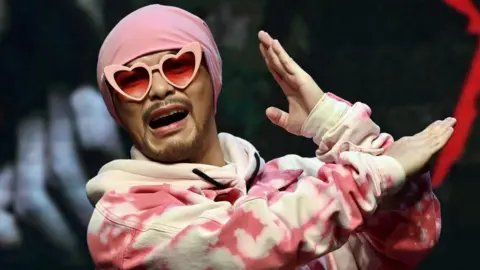 Controversy Unfolds as Malaysian Rapper Namewee Held in Influencer's Death Investigation