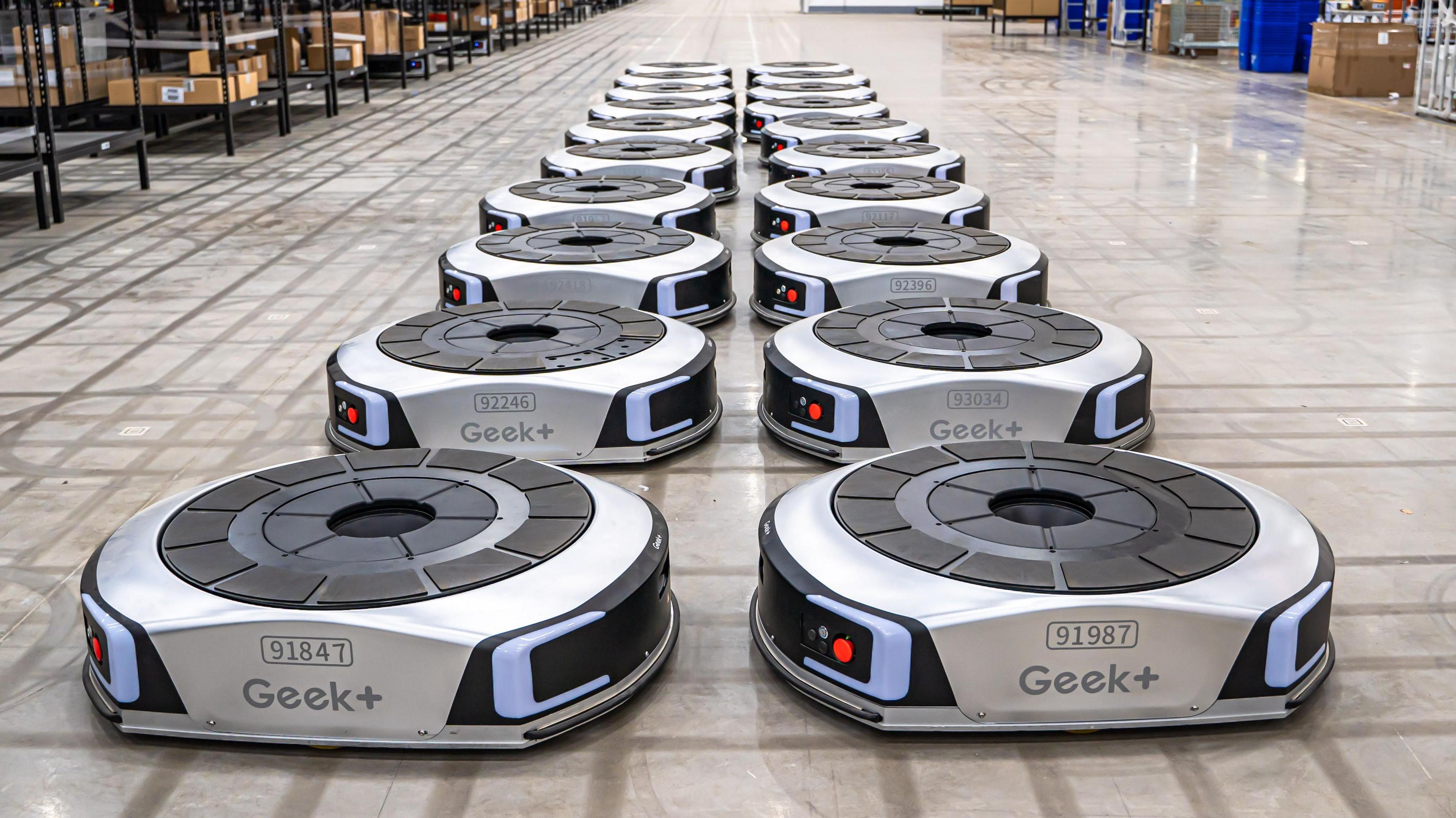 Geek+ floor robots lining up in a UK warehouse