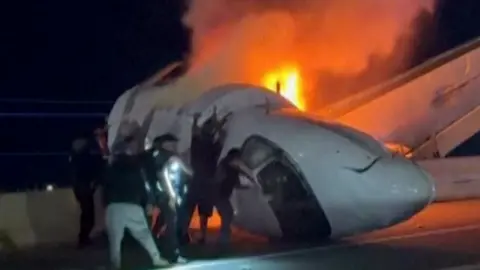 Bystanders in Texas Rescue Passengers from Flaming Jet Crash