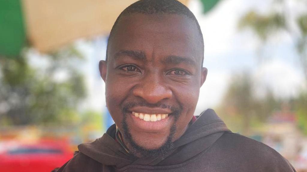 Simon Macharia Wangui wearing a black hoodie
